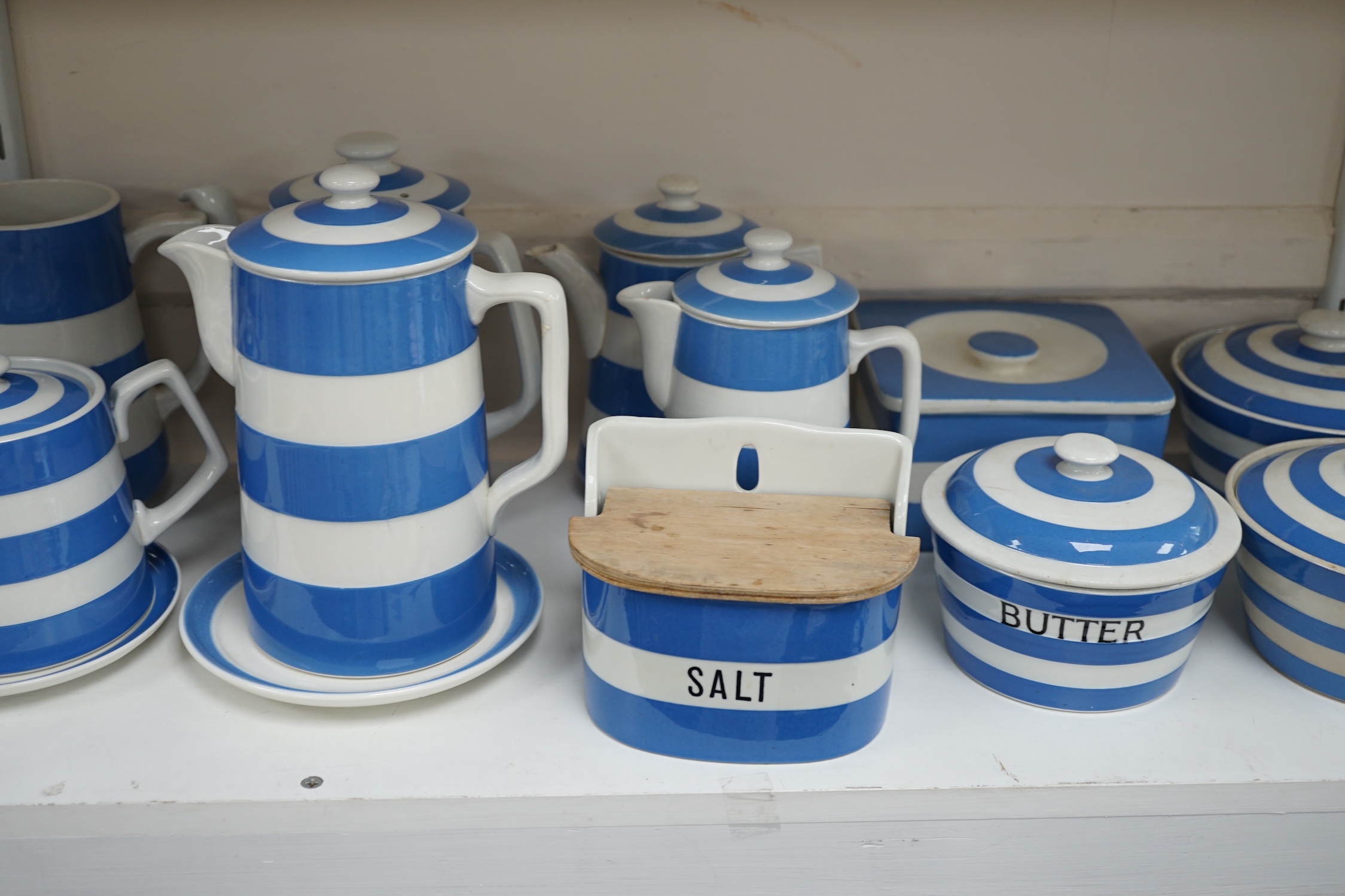 T.G.Green Cornish Kitchenware, eleven tea, coffee and hot water pots, two jugs, a salt pot, five Butter, Lard and Margarine lidded jars and one unnamed square jar, largest 20cm high, mixed marks. Condition - poor, fair a
